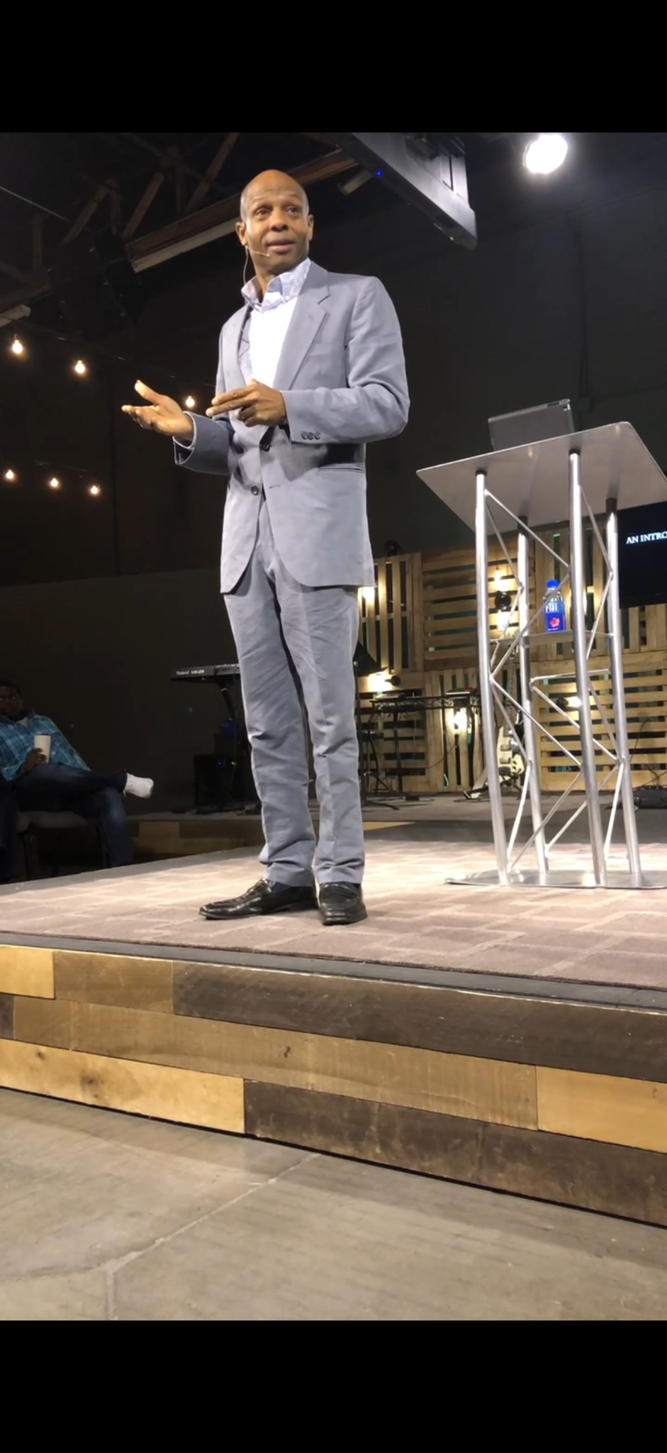 Dr. Kevin Armstrong teaching beside a lectern